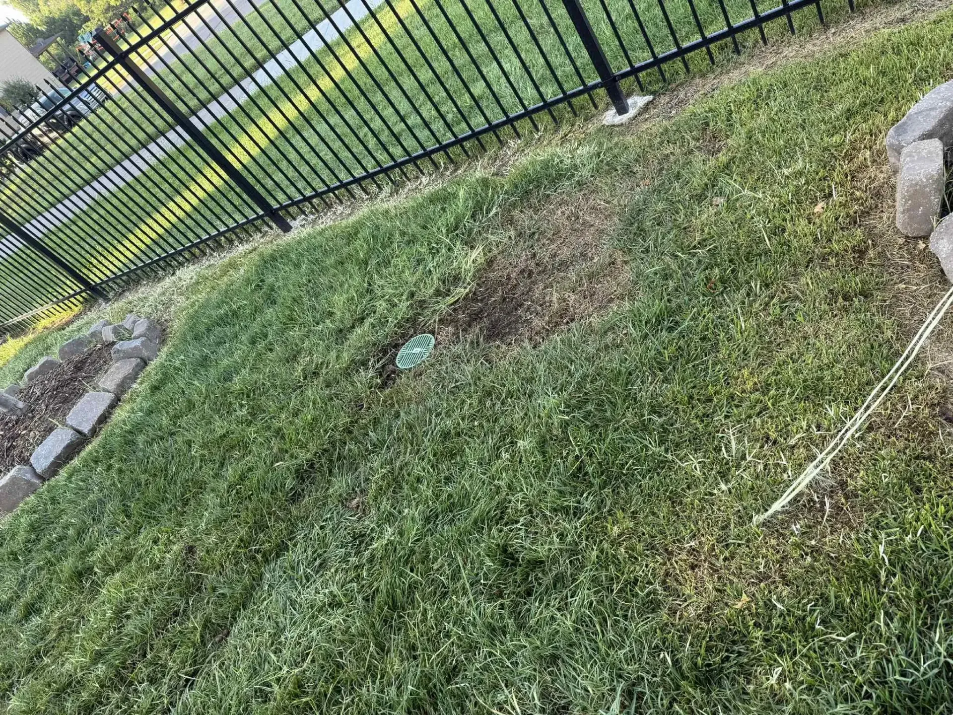 Lawn with a freshly installed underground drain with emitter
