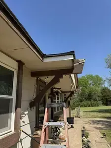 Side of house with fascia overhang being stripped and replaced in Wichita KS