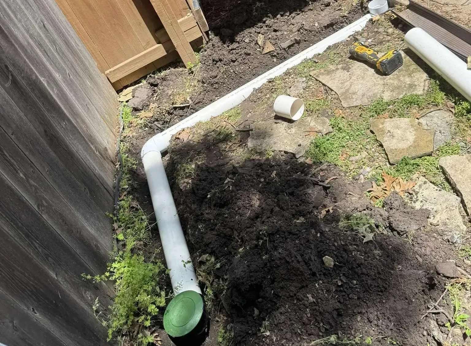 French drain through yard into the ground along a fench