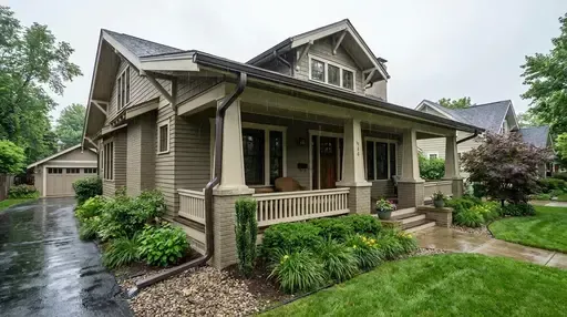 Wichita 2 story beautiful home, showcasing new gutter system into underground drain in the rain
