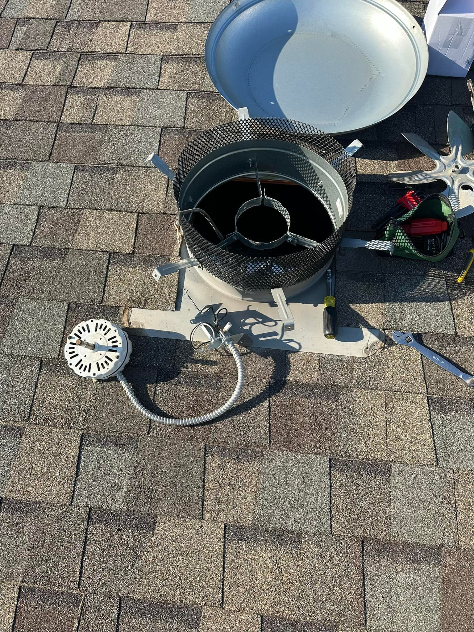 A clock is sitting on top of a brick roof.