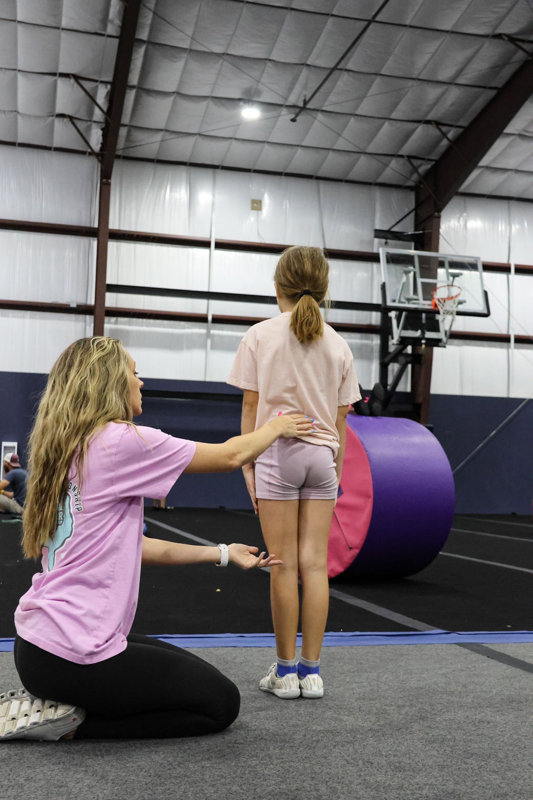 A group of young girls are posing for a picture in a dance studio