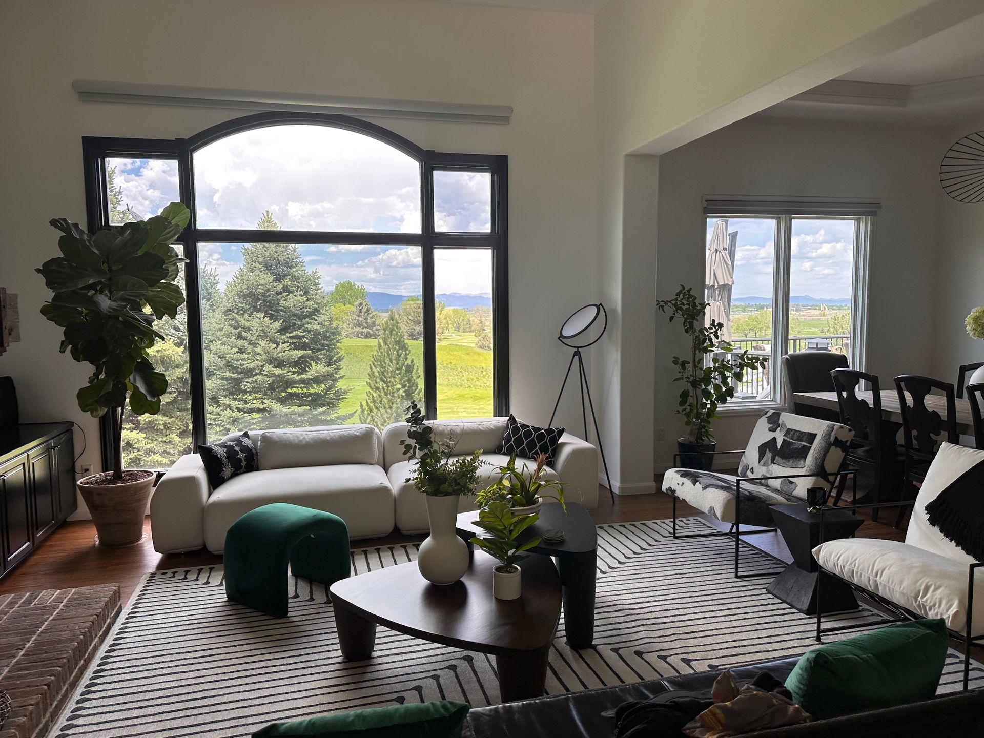 A living room filled with furniture and a large window.