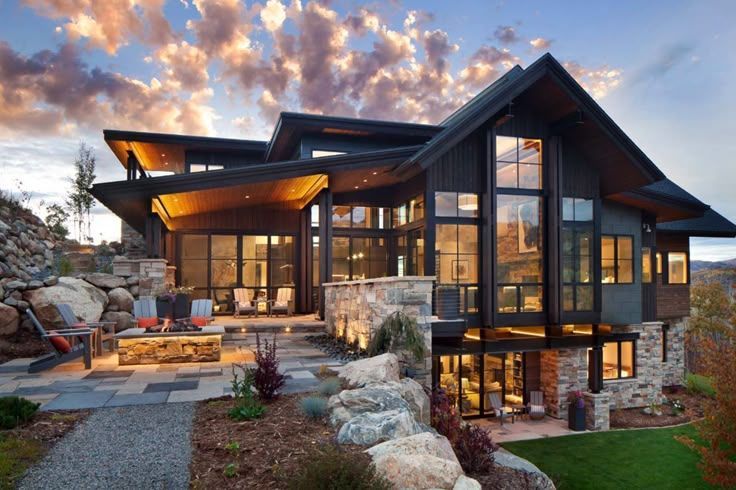 A large house with a lot of windows is sitting on top of a hill.