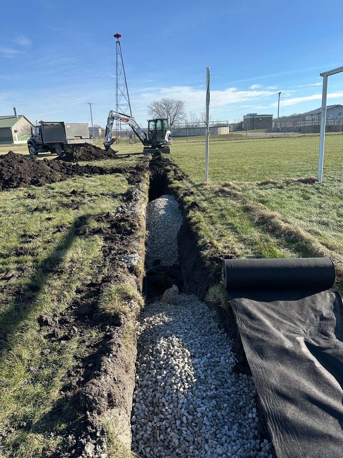 A drainage system is being installed in a field.