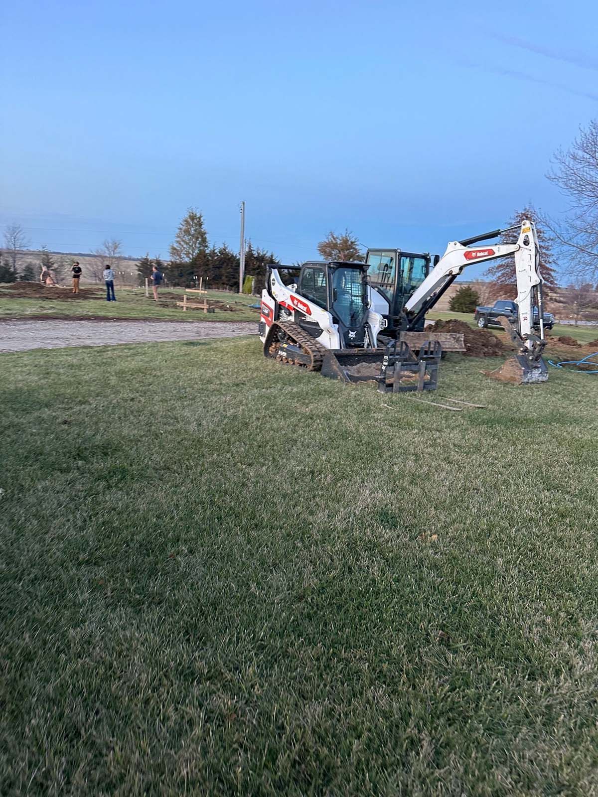 A bulldozer is sitting in the middle of a grassy field.
