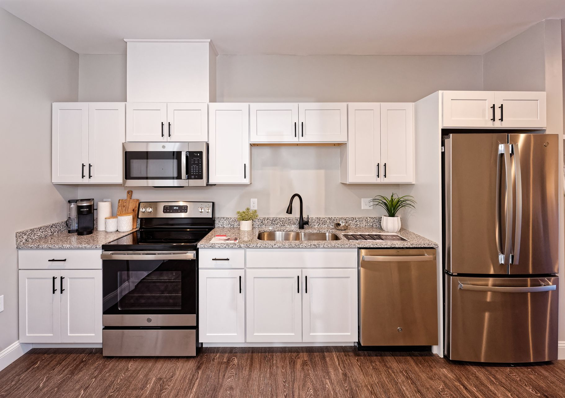 a laundry room with a washer and dryer stacked on top of each other .