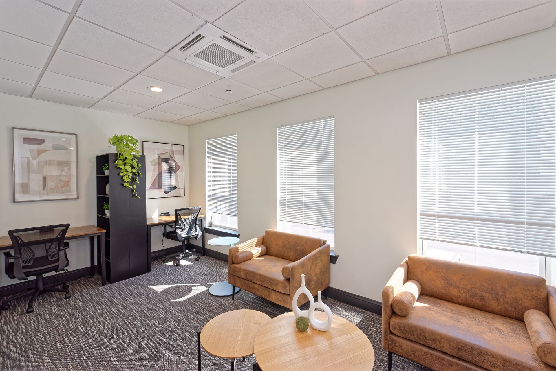 a long hallway with blue walls and a black door .