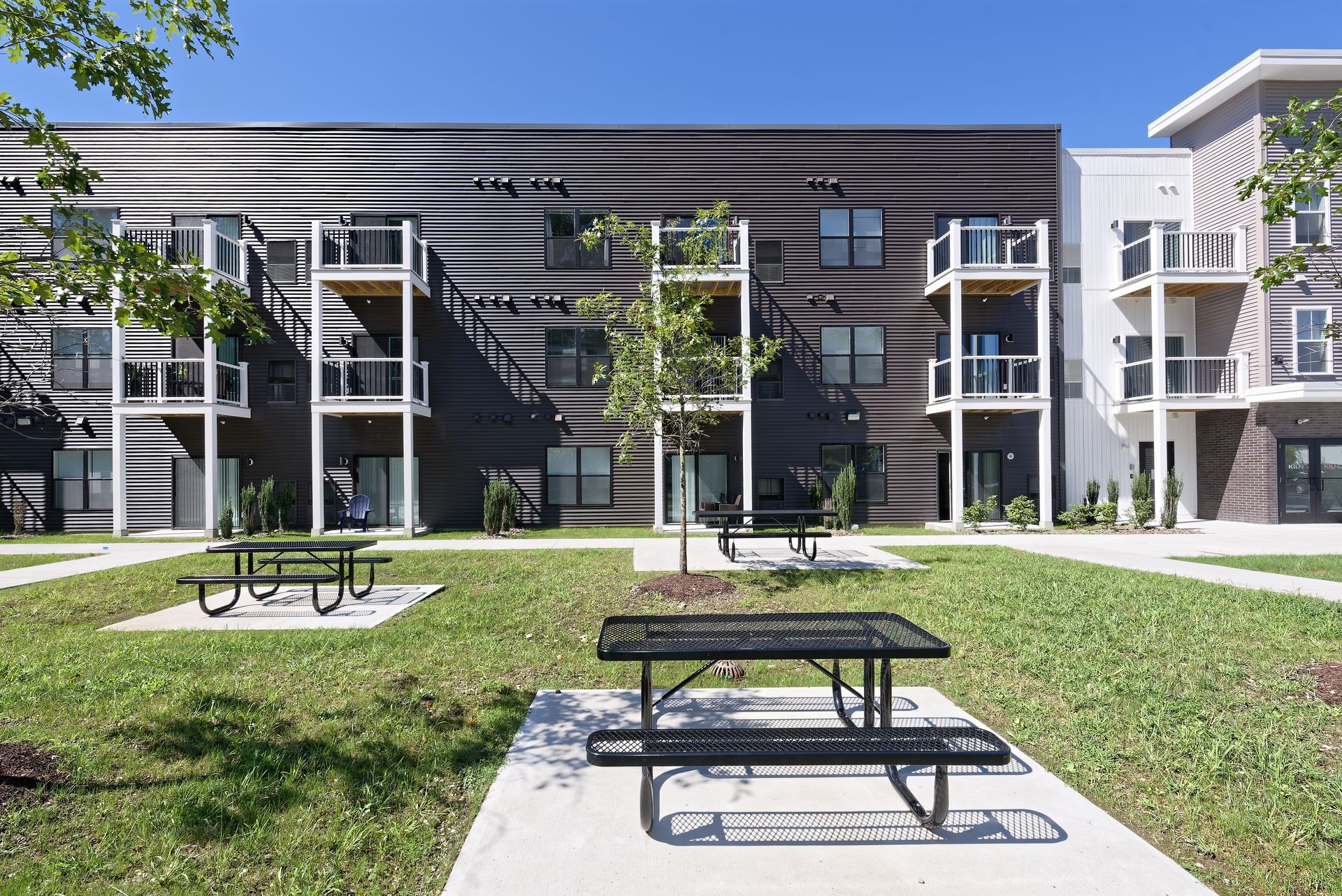 an aerial view of a large apartment building with a parking lot in front of it .