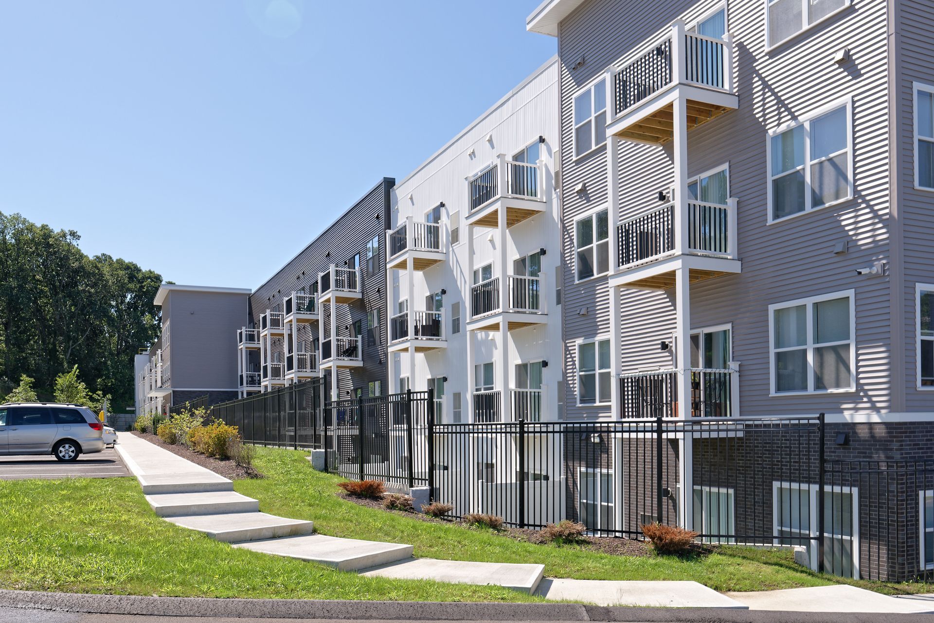 an aerial view of a large apartment building with a parking lot in front of it .
