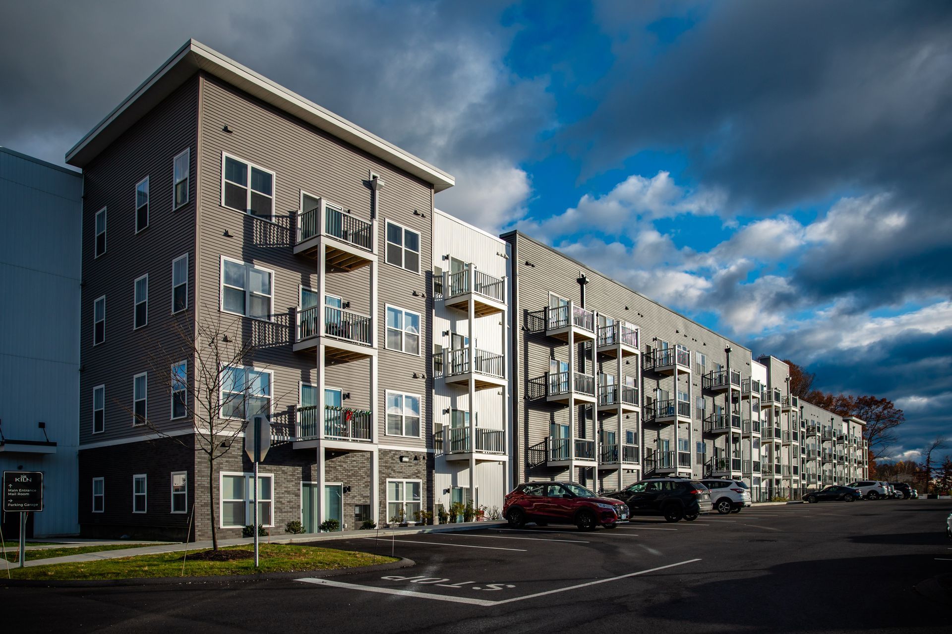 a large apartment building with a parking lot in front of it