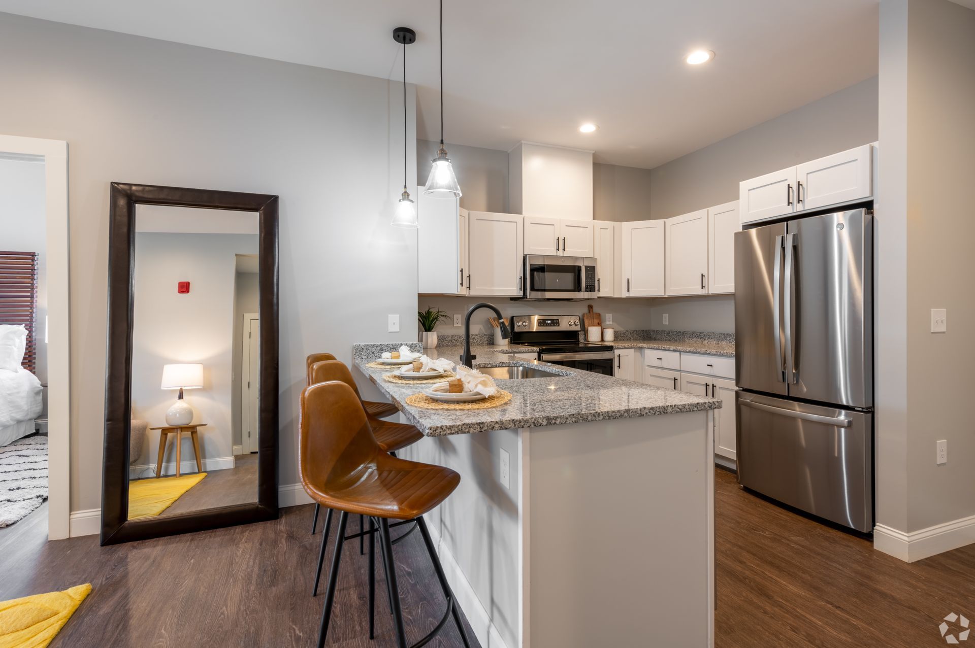 a kitchen with white cabinets and stainless steel appliances .