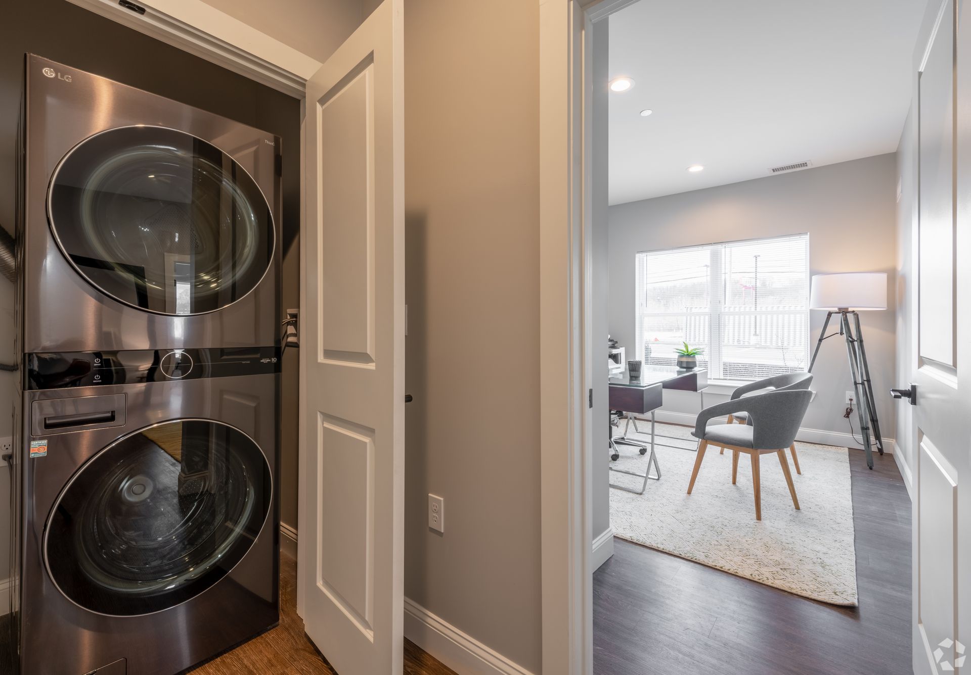 a washer and dryer are stacked on top of each other in a laundry room .