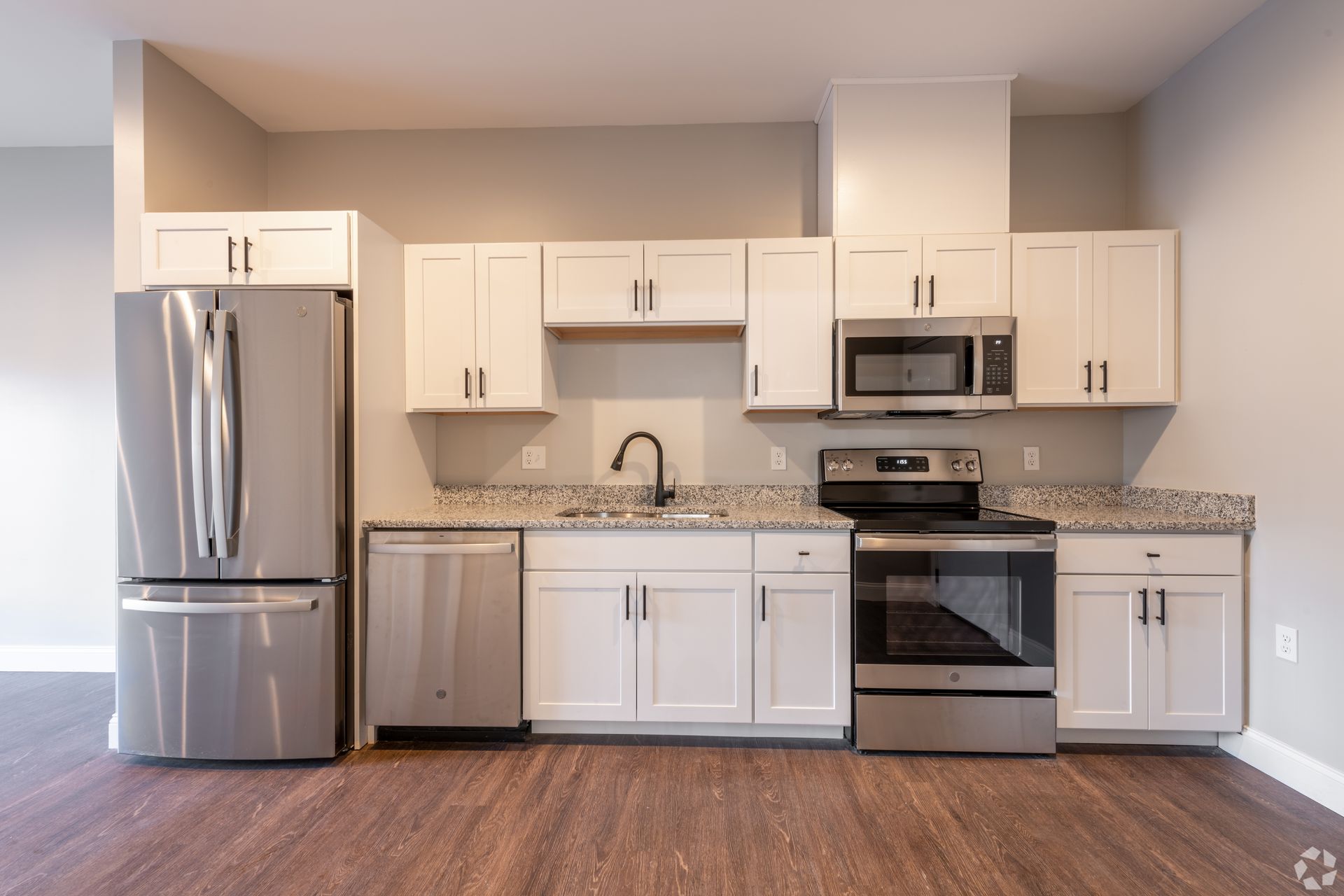 a kitchen with stainless steel appliances and granite counter tops .