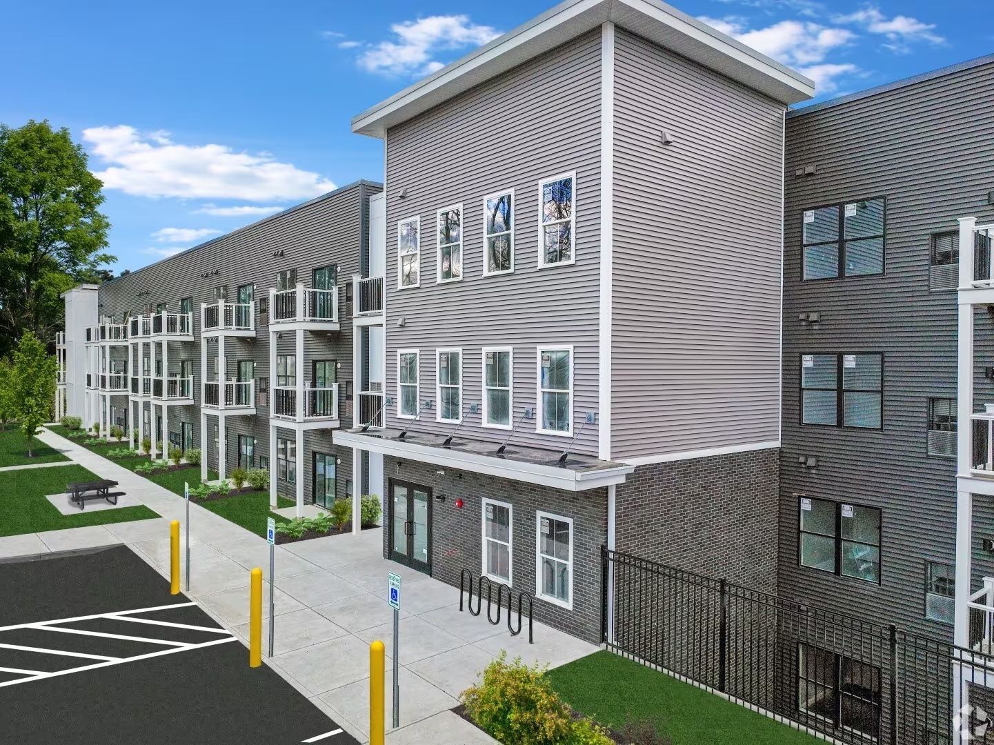 an aerial view of a large apartment building with a parking lot in front of it .