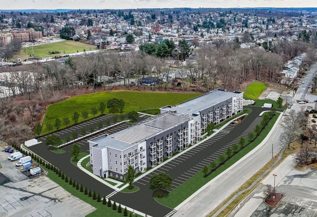 an aerial view of a building and a parking lot in a city .