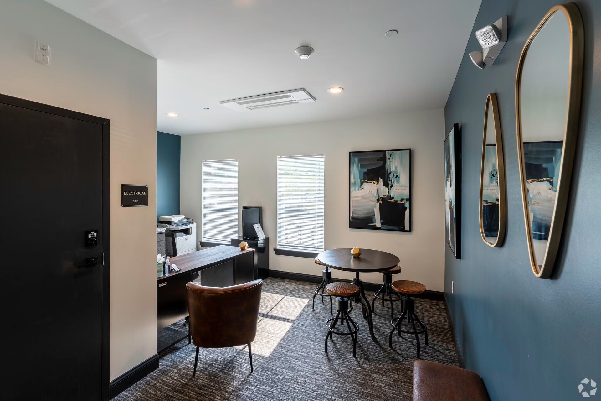 a room with a table and chairs in it and a mirror on the wall .