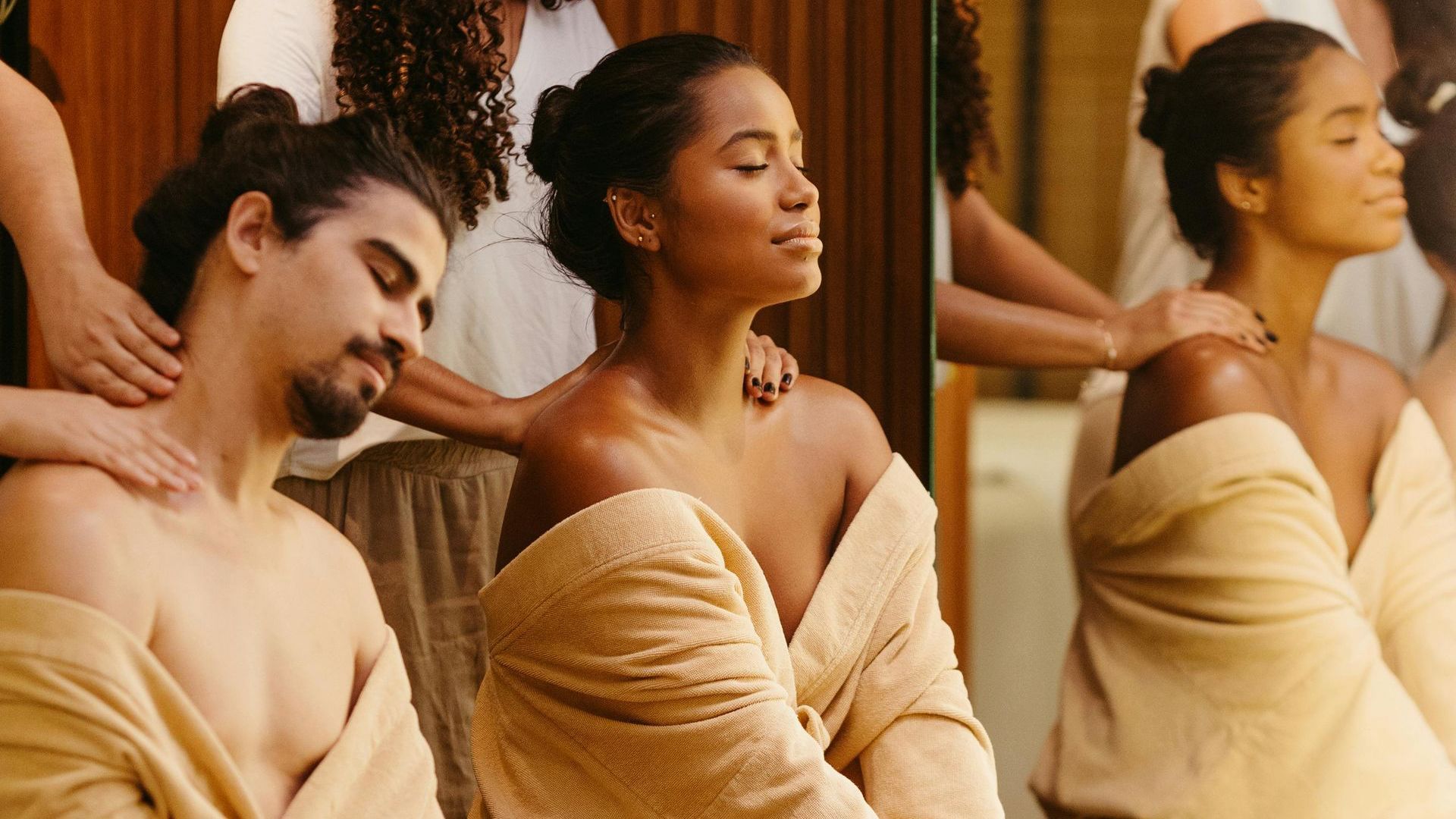 A man and a woman are getting a massage at a spa.