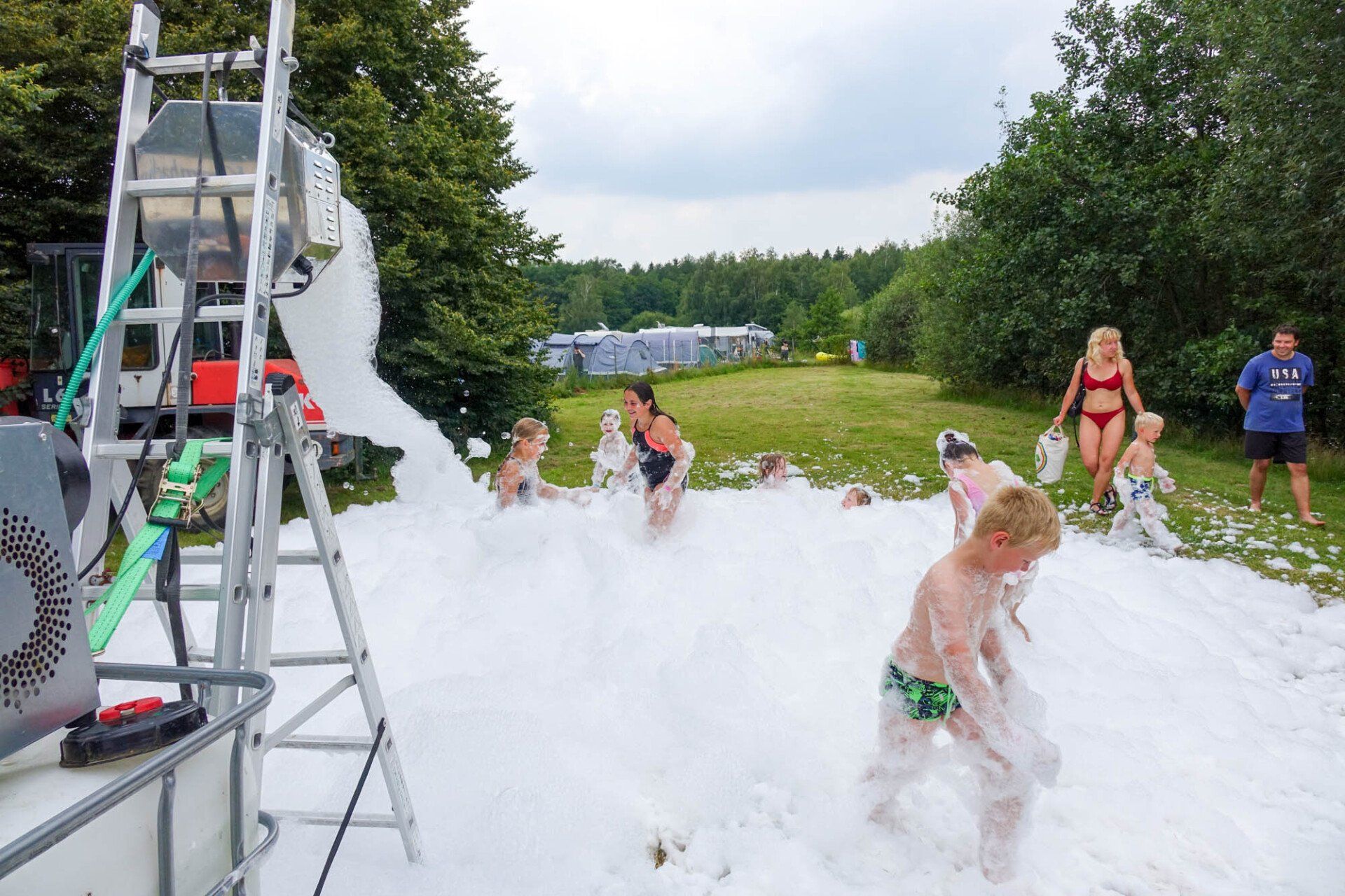 Kinder spielen im Freien in einem großen Schaumstoffhaufen