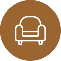 An icon of a chair in a brown circle.