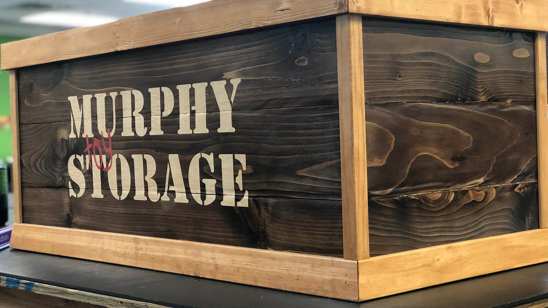 A wooden box with the words murphy storage written on it.
