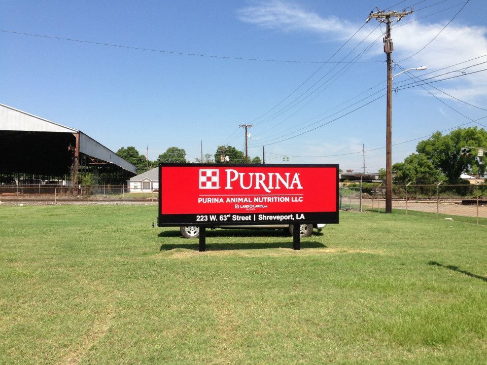 A large red sign that says purina on it