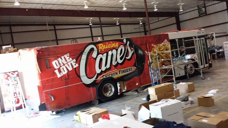 A red cane 's truck is parked in a warehouse.
