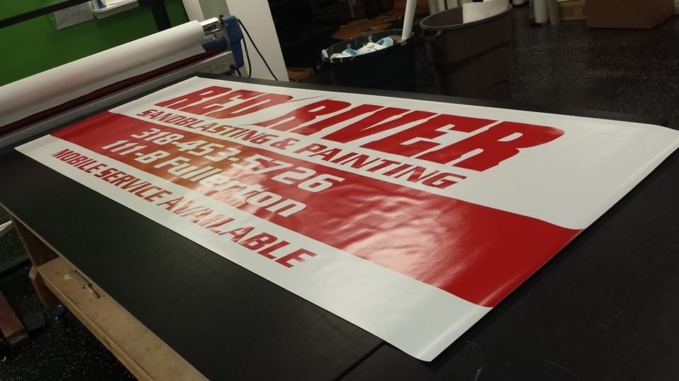 A large red and white sign for red river painting