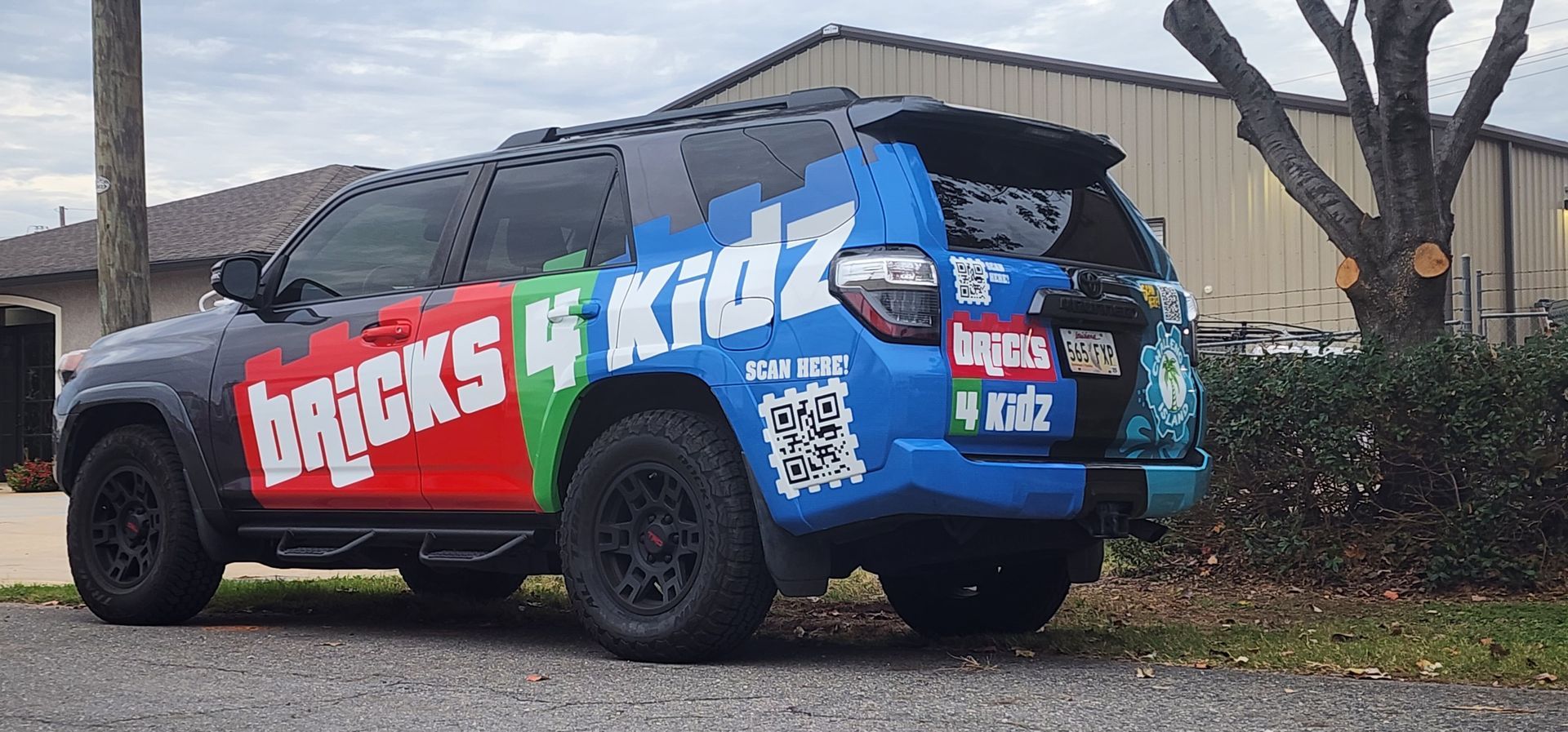 A bricks and kidz truck is parked on the side of the road.