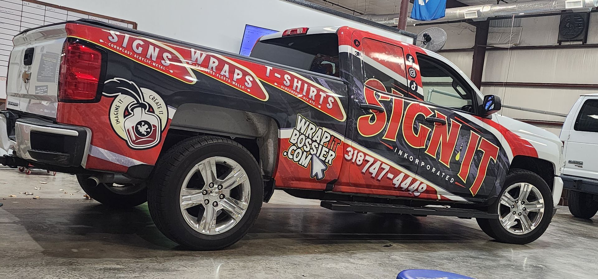 A red and black truck is parked in a parking lot.