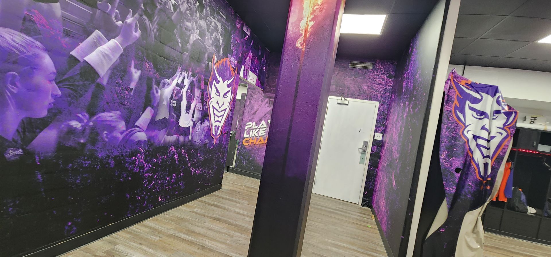 A hallway with purple walls and a painting on the wall.