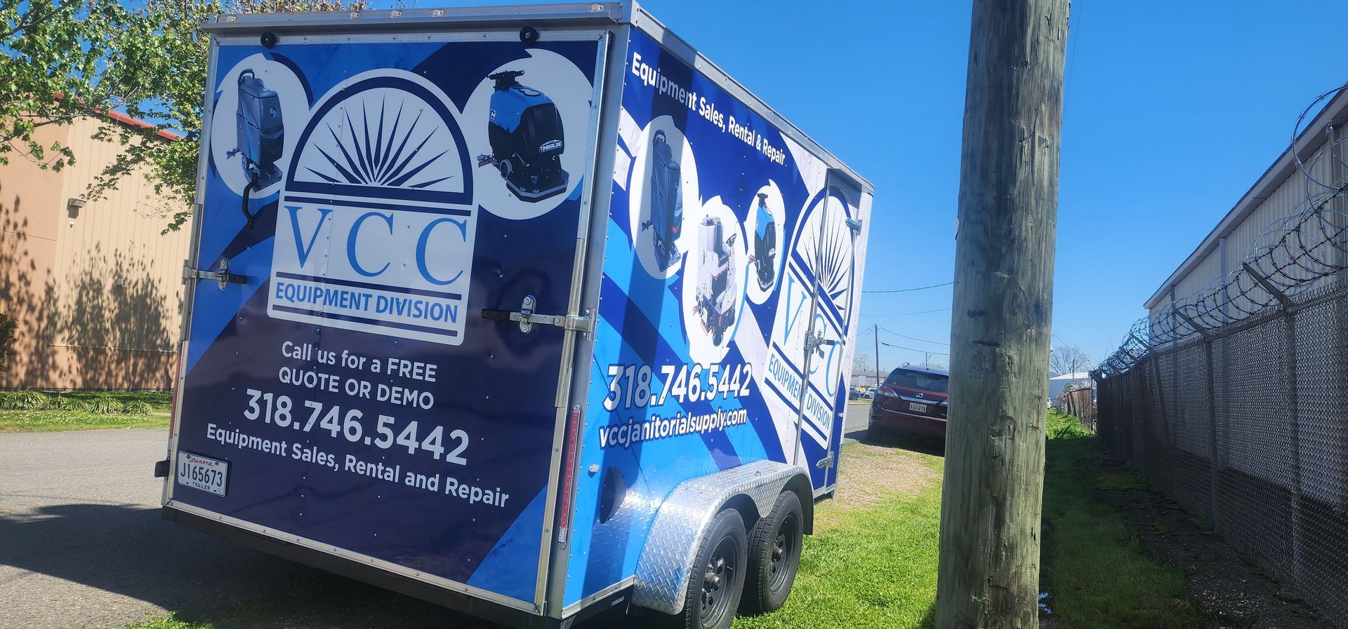 A blue trailer is parked on the side of the road.