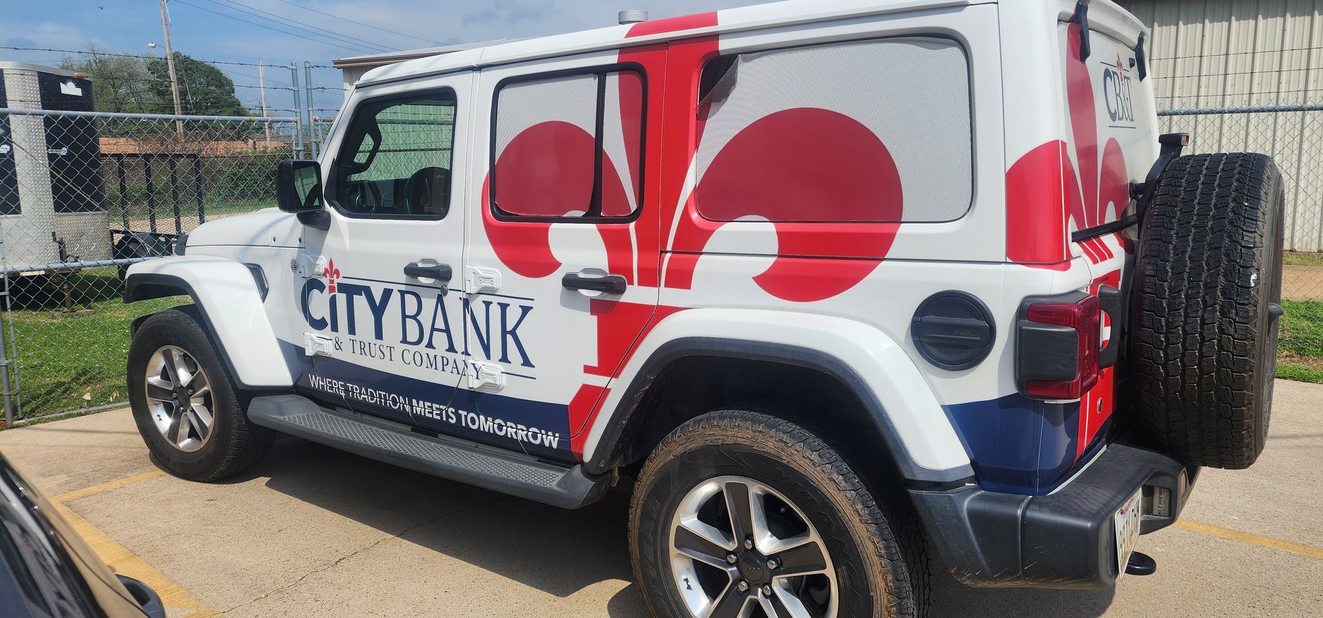 A white and red jeep is parked in a parking lot.