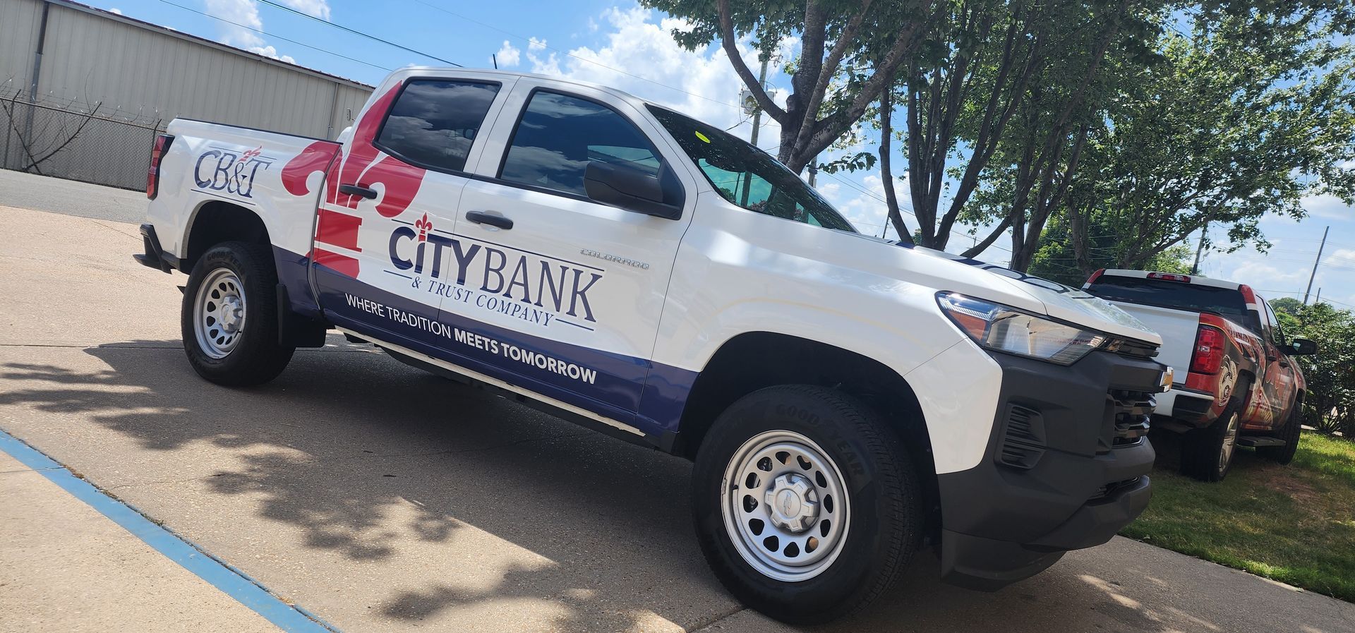 A city bank truck is parked in a parking lot.
