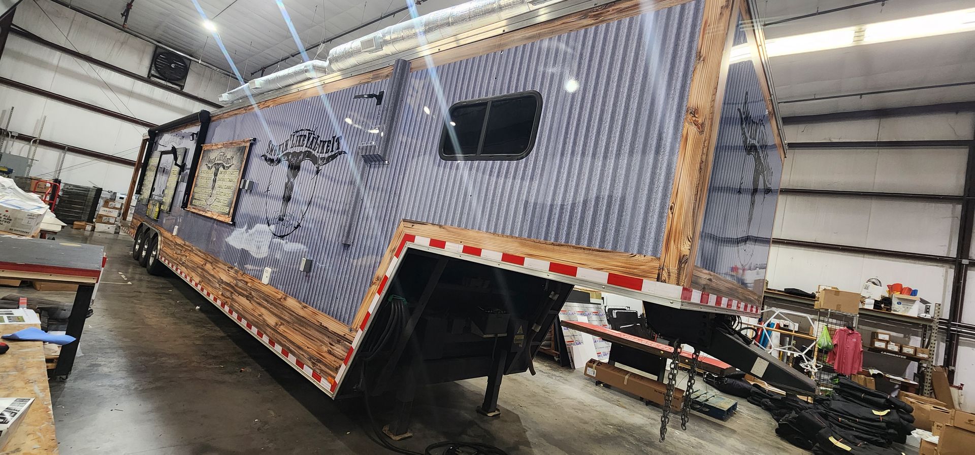 A large trailer is being built in a garage.