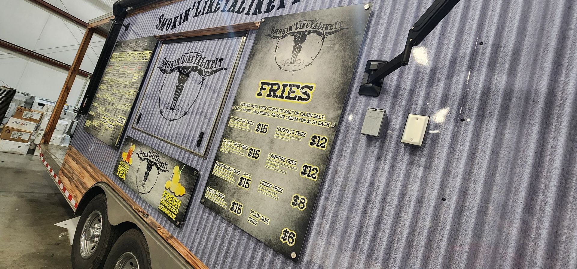 A food truck with a menu on the side of it.