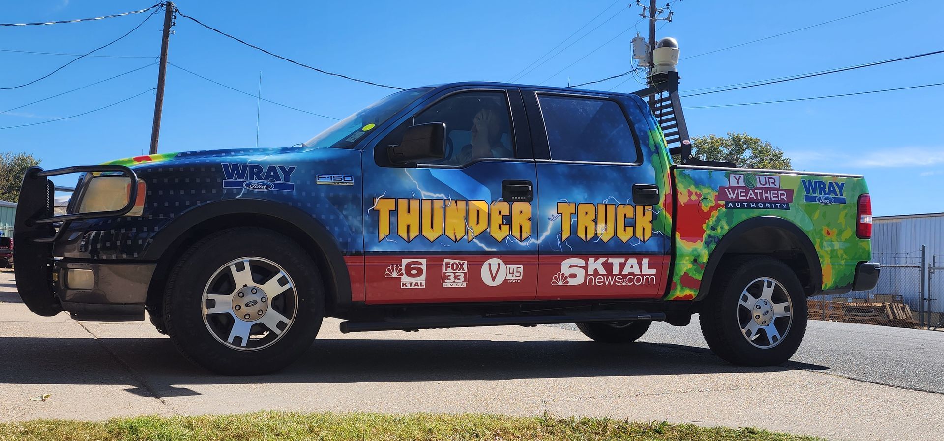 A thunder truck is parked on the side of the road