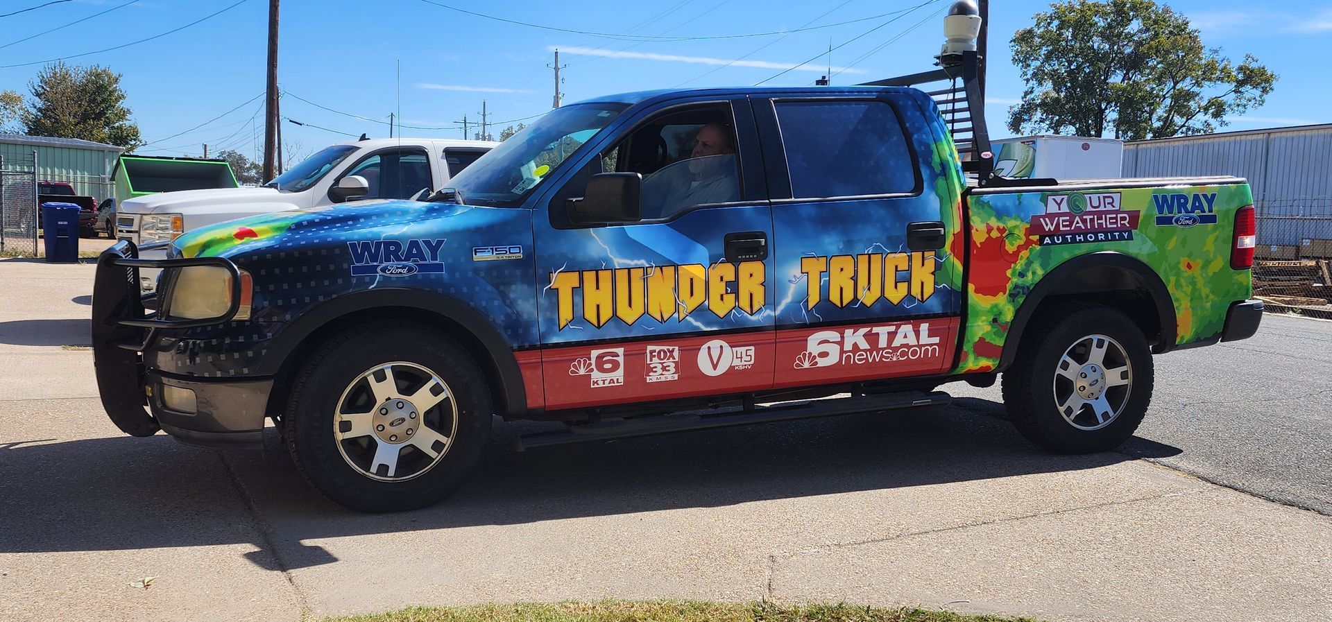 A thunder truck is parked on the side of the road
