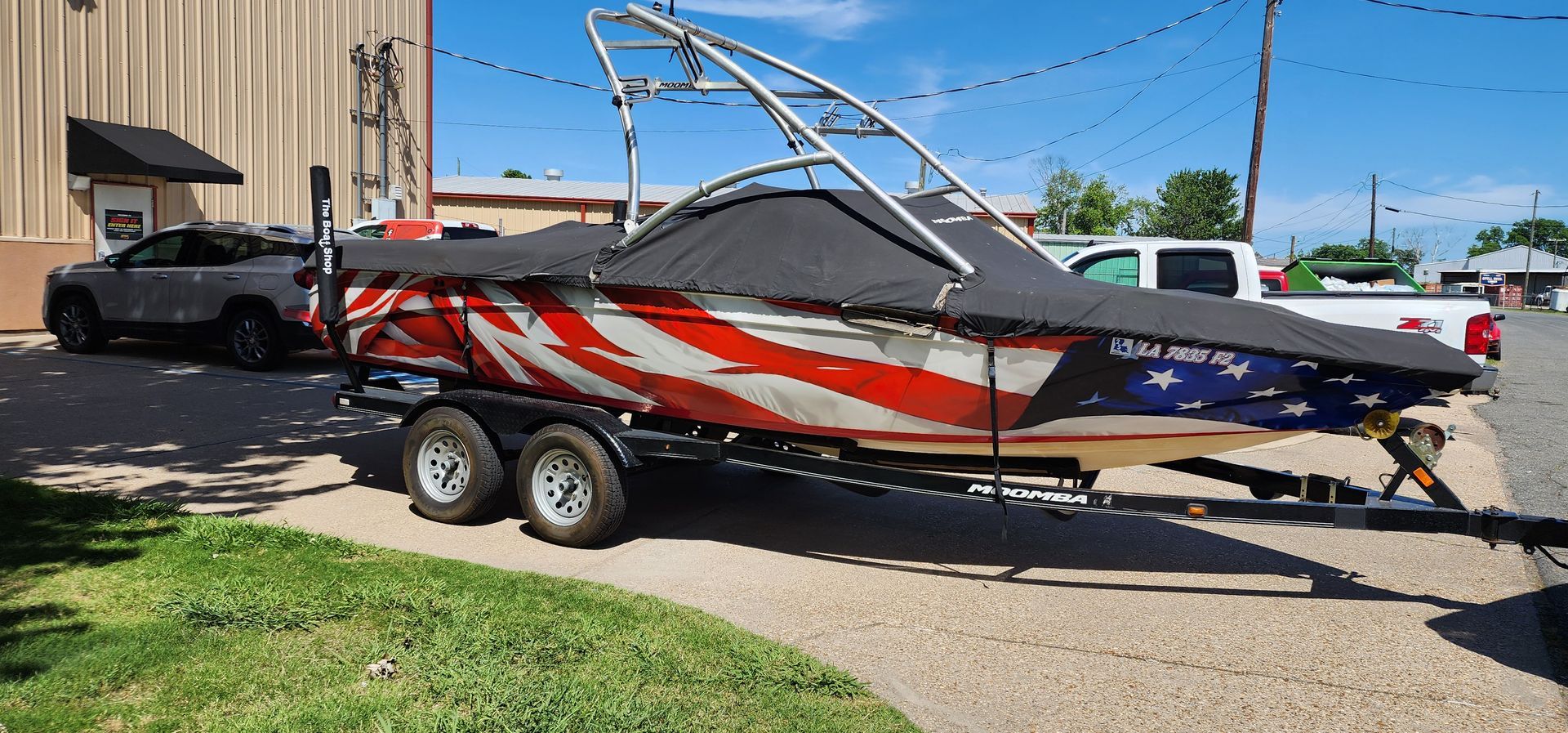 A boat with an american flag painted on it is on a trailer.
