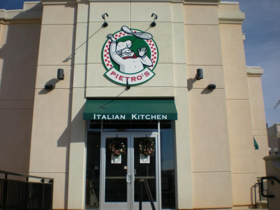 The entrance to pietro 's italian kitchen with a green awning