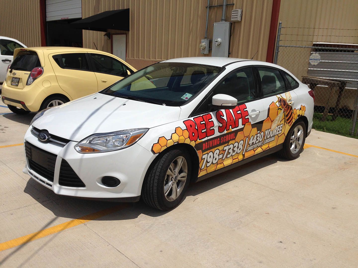 A bee safe car is parked in a parking lot