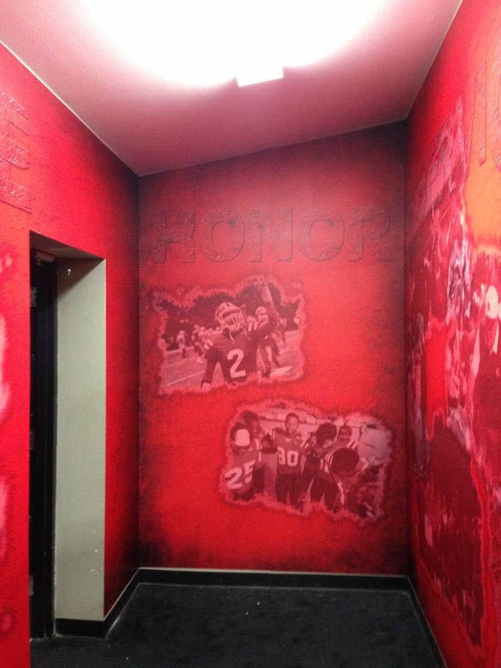 A room with red walls and graffiti on them