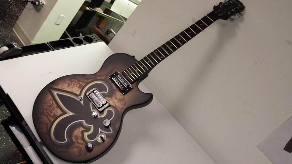 A guitar with a fleur de lis design on it