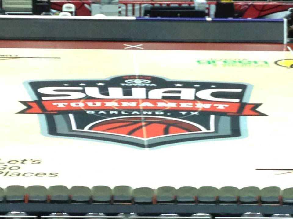 A basketball court with a swag tournament logo on it