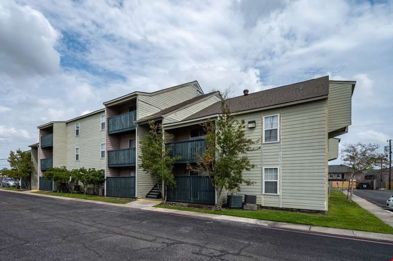 A large apartment building with a lot of windows and balconies.