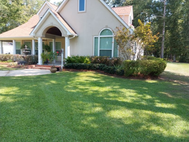 A house with a large lawn in front of it
