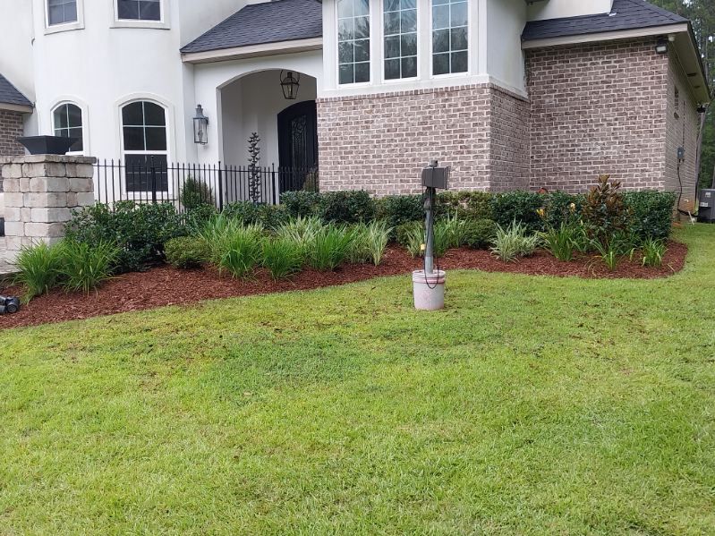 A large house with a lush green lawn in front of it.