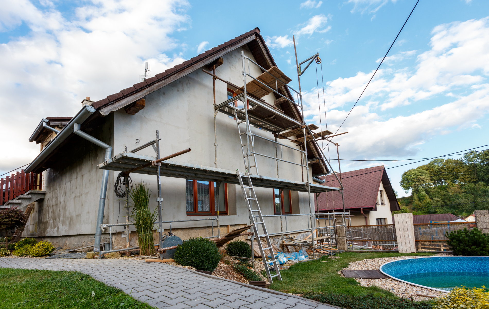 A house is being painted with scaffolding in front of it.