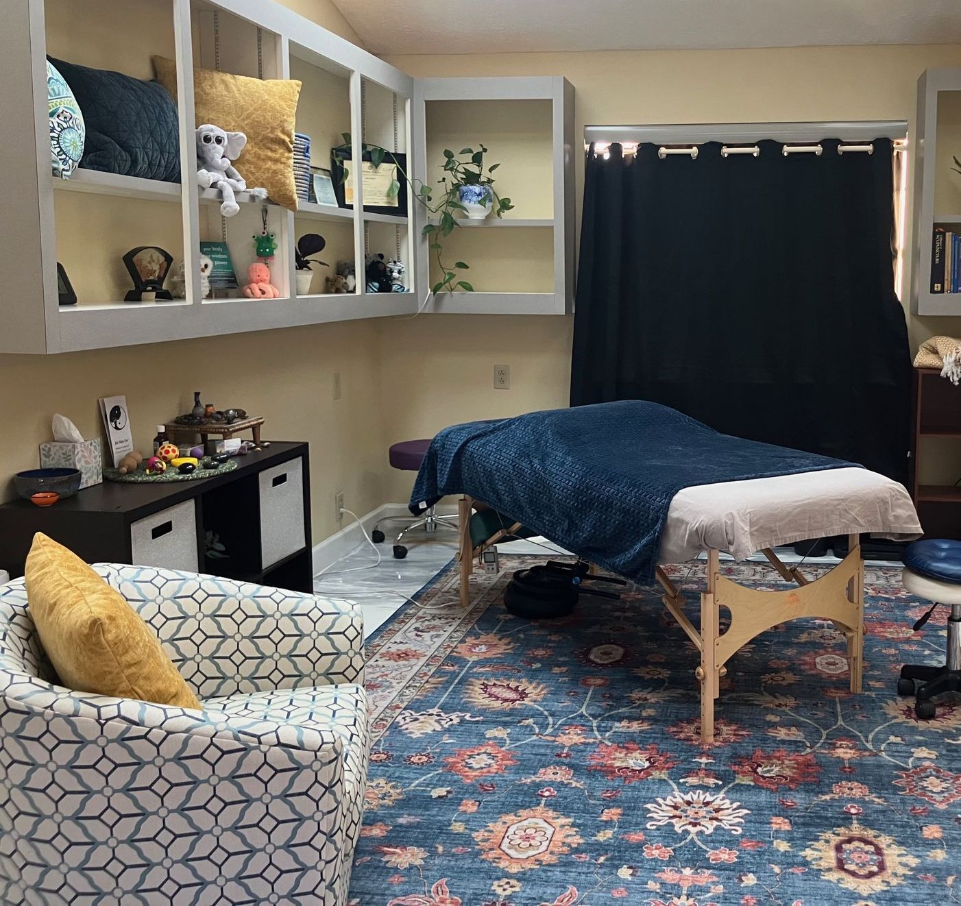 Lisa's bodywork office.  massage table in a room with a picture of mountains on the wall.