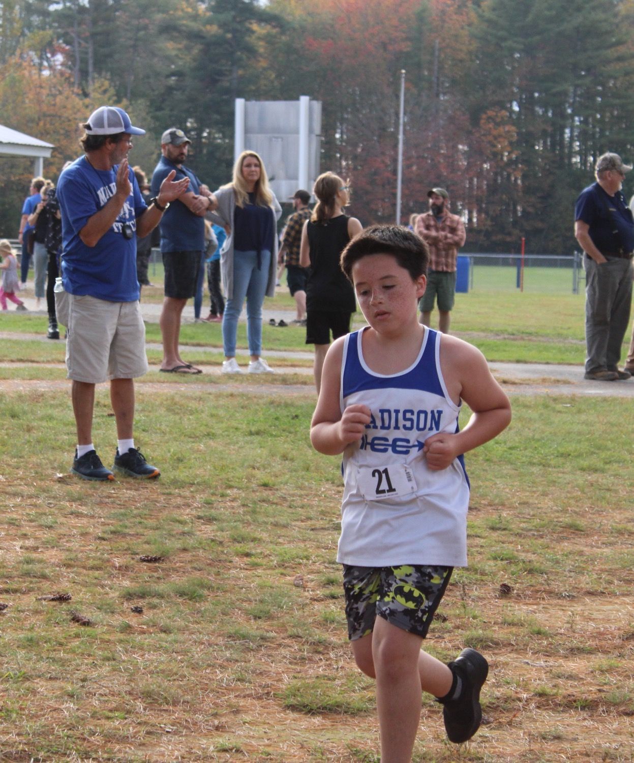 A boy wearing a tank top that says addison on it